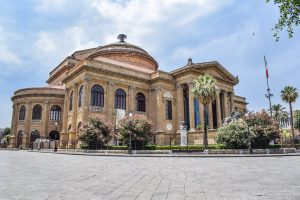 ancient building of opera house located on well groomed square against blue sky